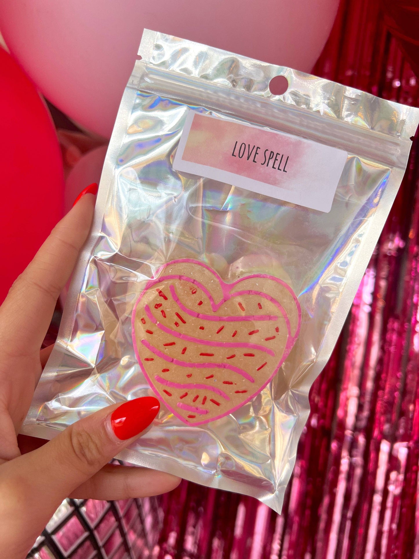 Shiny holographic "Pink Heart Cake Freshie: Love Spell" bag with heart-shaped, pink sprinkle-topped freshie. Available in S/M/L.