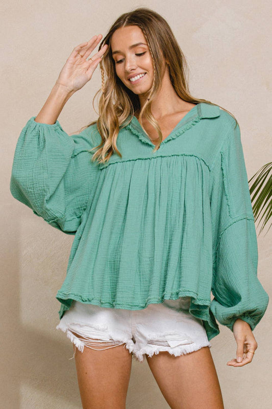 This product is a Cotton Gauze Top in Sage Green. It is a flowing style, offering a relaxed and comfortable fit. Sizes available range from small to extra-large.