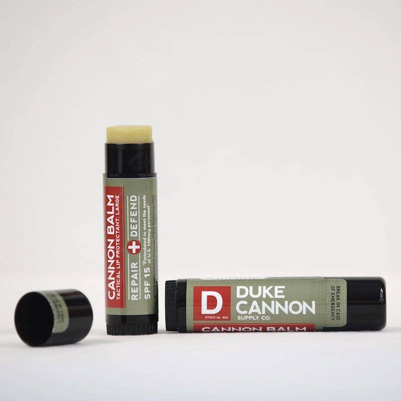 Two Cannon Balm tubes, one open and one closed, labeled "Repair + Defend SPF 15." Available in 0.15 oz size.