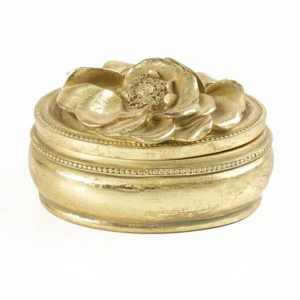 White Patchouli et Blanc Medium Gold Candle in a round gold vessel with floral lid, petal-beaded details; medium size.