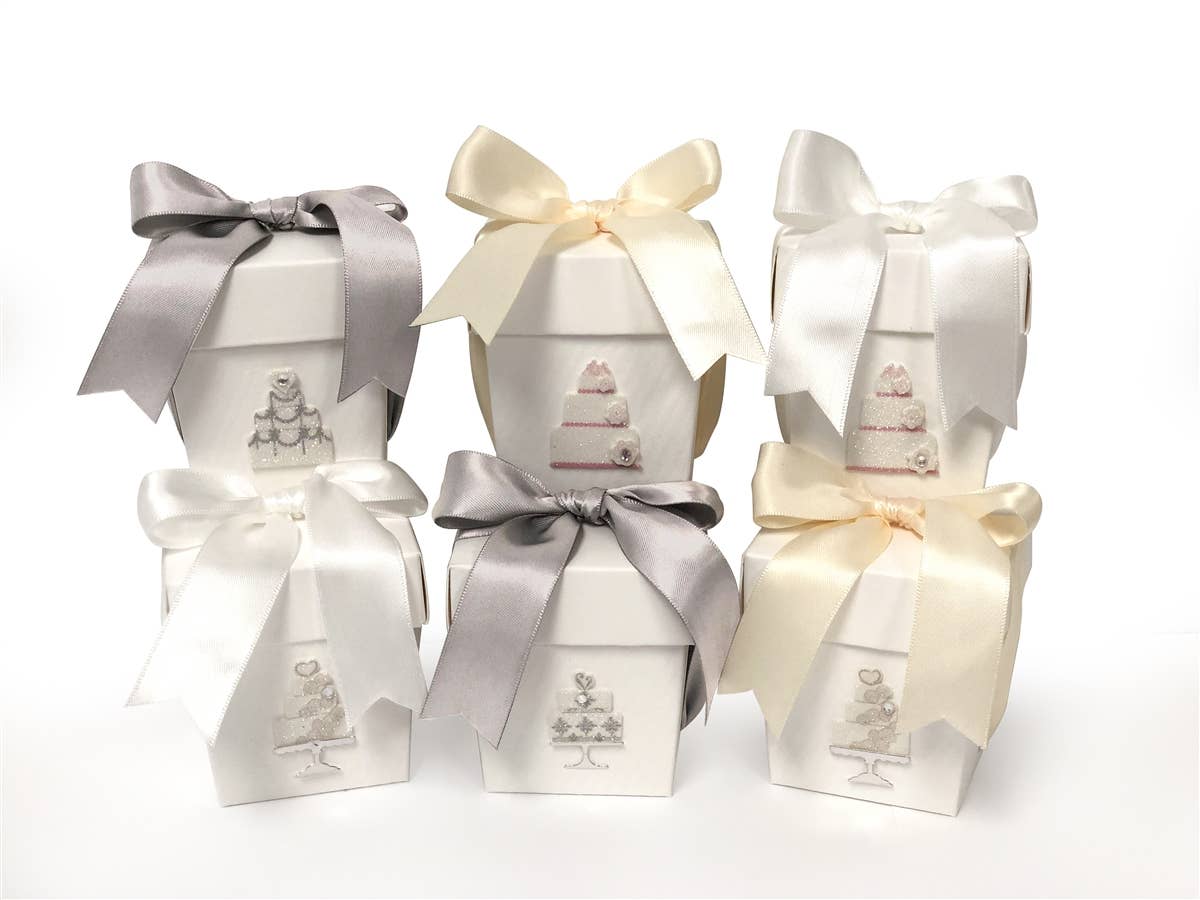 Six small white boxes with gray or cream bows and embossed cake designs. Available in mini size for the Wedding Cake Candle.