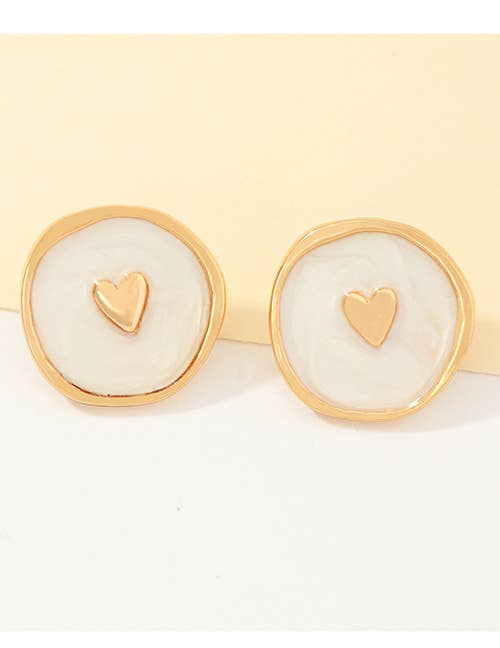 Round gold earrings with a white enamel center and small gold heart. Available in small and medium sizes.