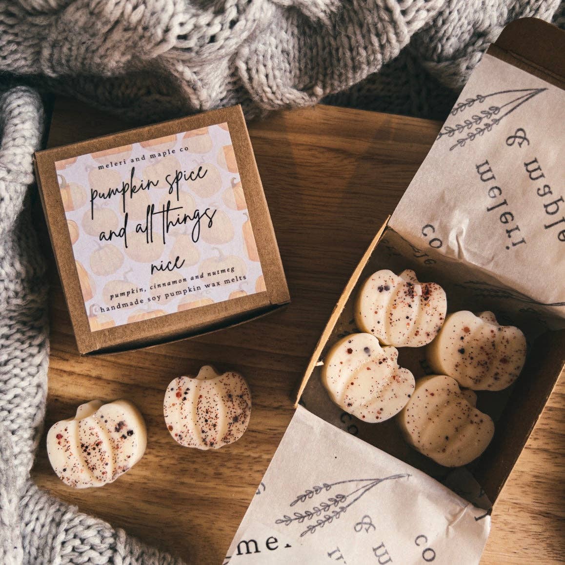 An open box of Hello Autumn Pumpkin Patch Soy Wax Melts with chunky pumpkin-shaped melts sprinkled with spices. Sizes available: not specified.