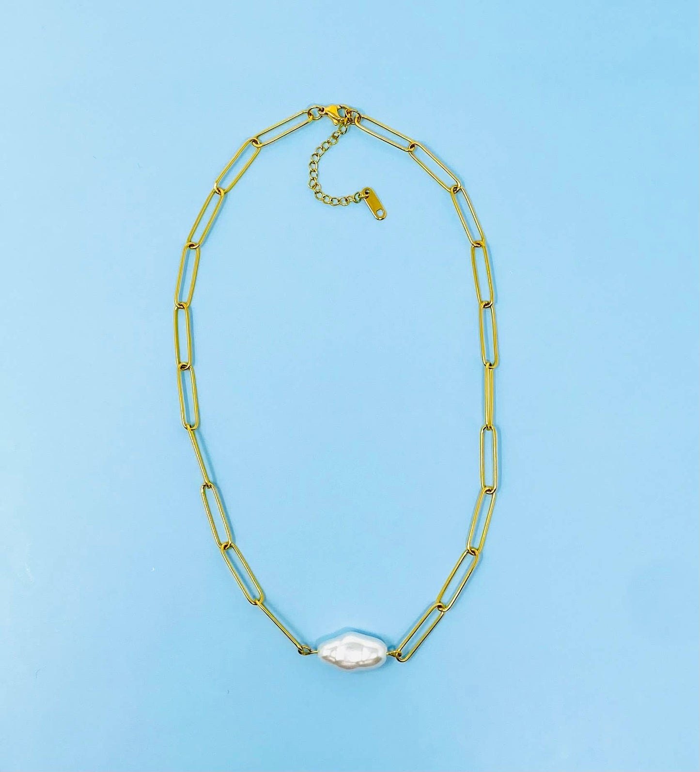 Gold-plated paperclip chain necklace with a single irregular white pearl centerpiece. Available in 16", 18", and 20" lengths.