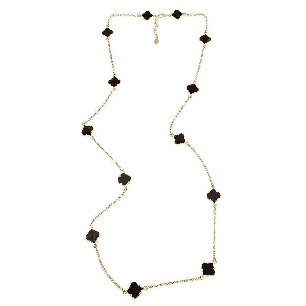 Gold chain necklace with evenly spaced black quatrefoil charms, delicate clasp, adjustable length. Sizes available.