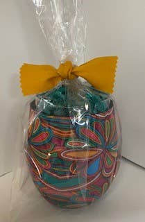Wine Huggie stemless cup with colorful patterns, wrapped in clear plastic and topped with a yellow bow. Available in multiple sizes.