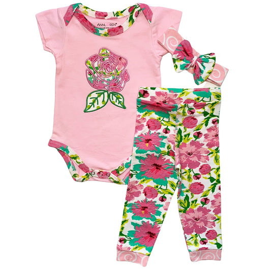 Three piece set with pink onesie with embroidered flower and print trim, floral design mainly pink pants, and pink bow headband with floral design bow.