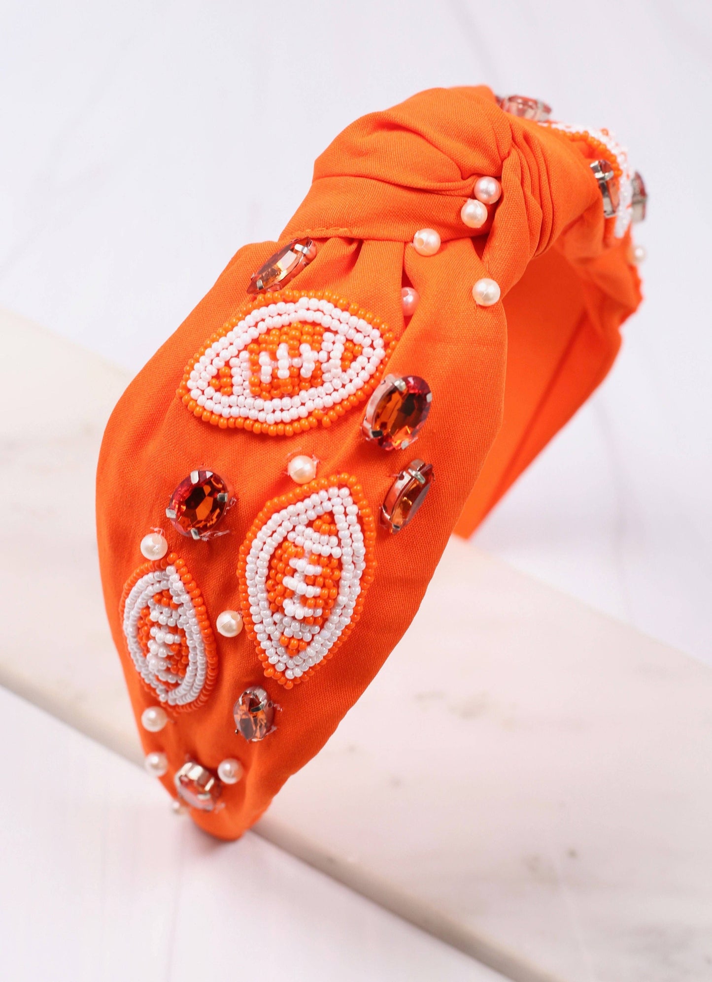 The Game Day Headband with orange beads, pearls, and amber gemstones on fabric. Available in S/M and M/L.