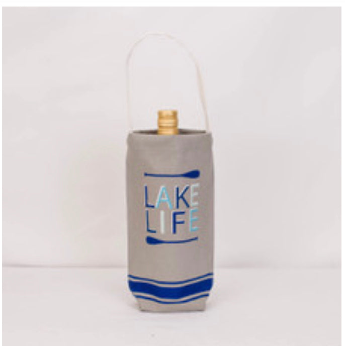 Beige canvas wine bag with handle, gray and blue paddles, "Lake Life" on front. Fits one bottle. Available in one size.