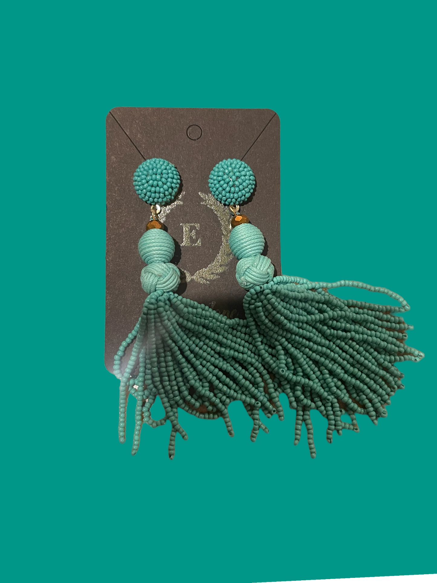 Teal beaded tassel earrings with stud tops, long textured strands. Available in one size.