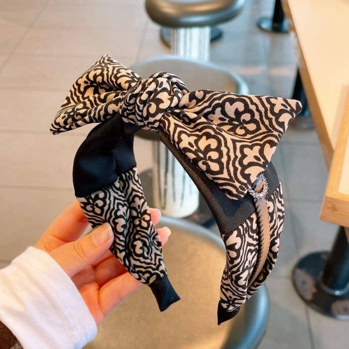 HA826 Floral headband with leather strap and large shapeable black and white floral bow. Available in S, M, and L.