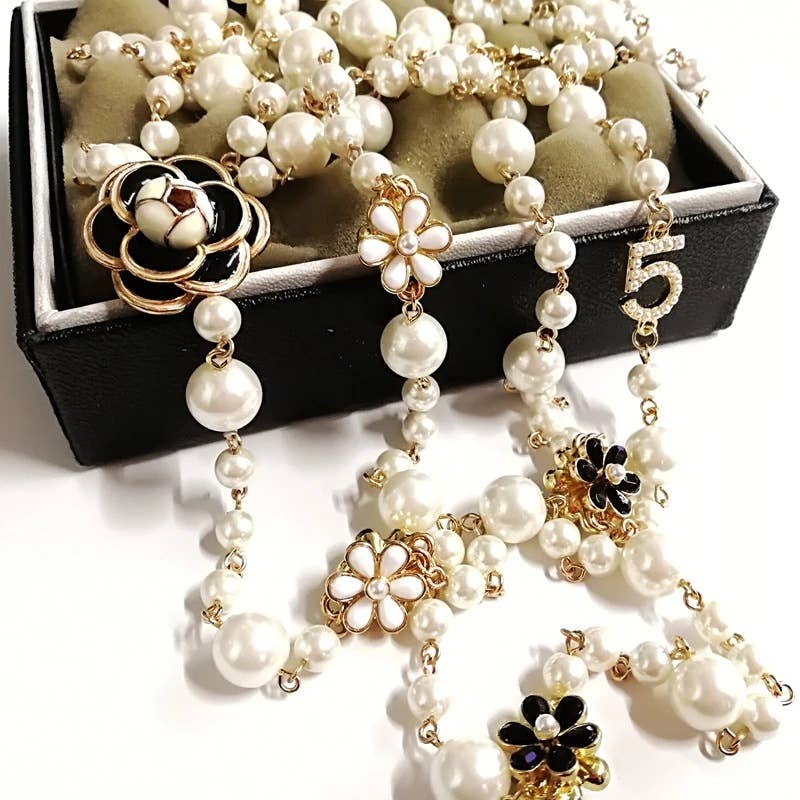 EUR153 large camelia chunky long necklace in Ivory with pearl, gold beads, black/white flower charms, gold 5 pendant. Sizes: Large.