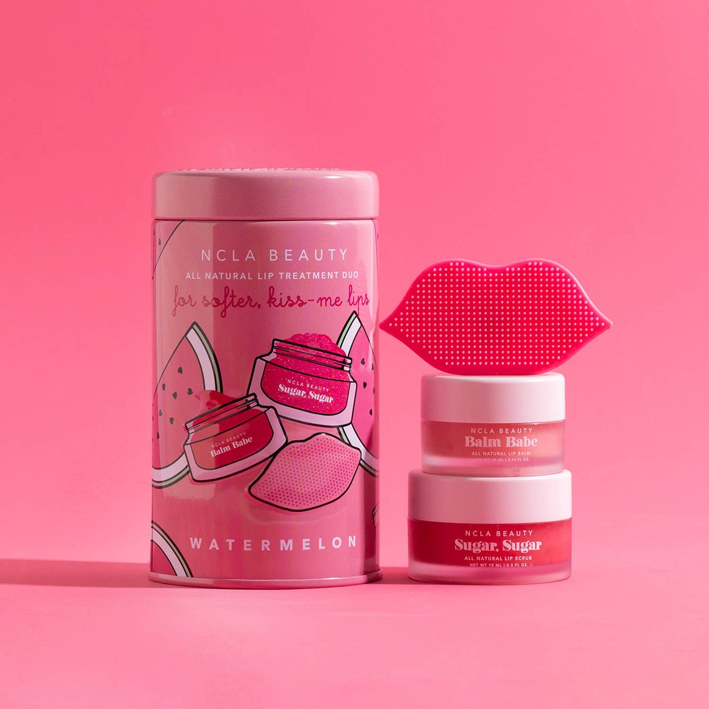 Pink tin "Watermelon Lip Care Set + Lip Scrubber," includes lip-shaped scrubber and two vegan jars; sizes: standard only.