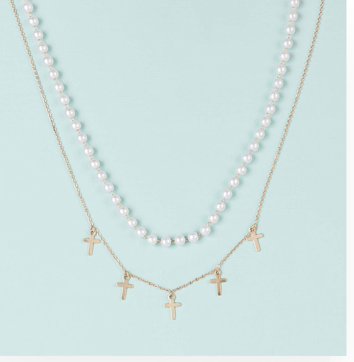 The Callie Necklace: brass-plated gold chain with five small gold cross pendants. Available in 16" and 18" lengths.