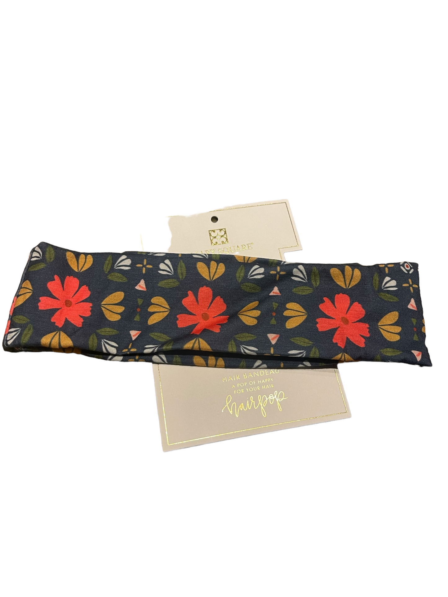 Dark-colored fabric hair bandeau with red, yellow, and green floral patterns. Available sizes: S, M, L.