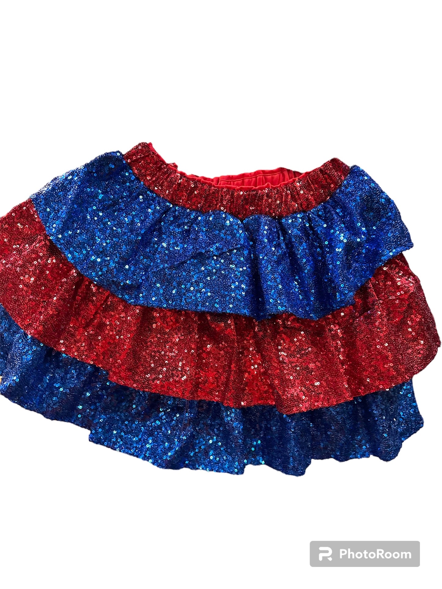 Red and blue sequin mini skirt with sparkly fabric, elastic waistband; available in sizes XS–XL.