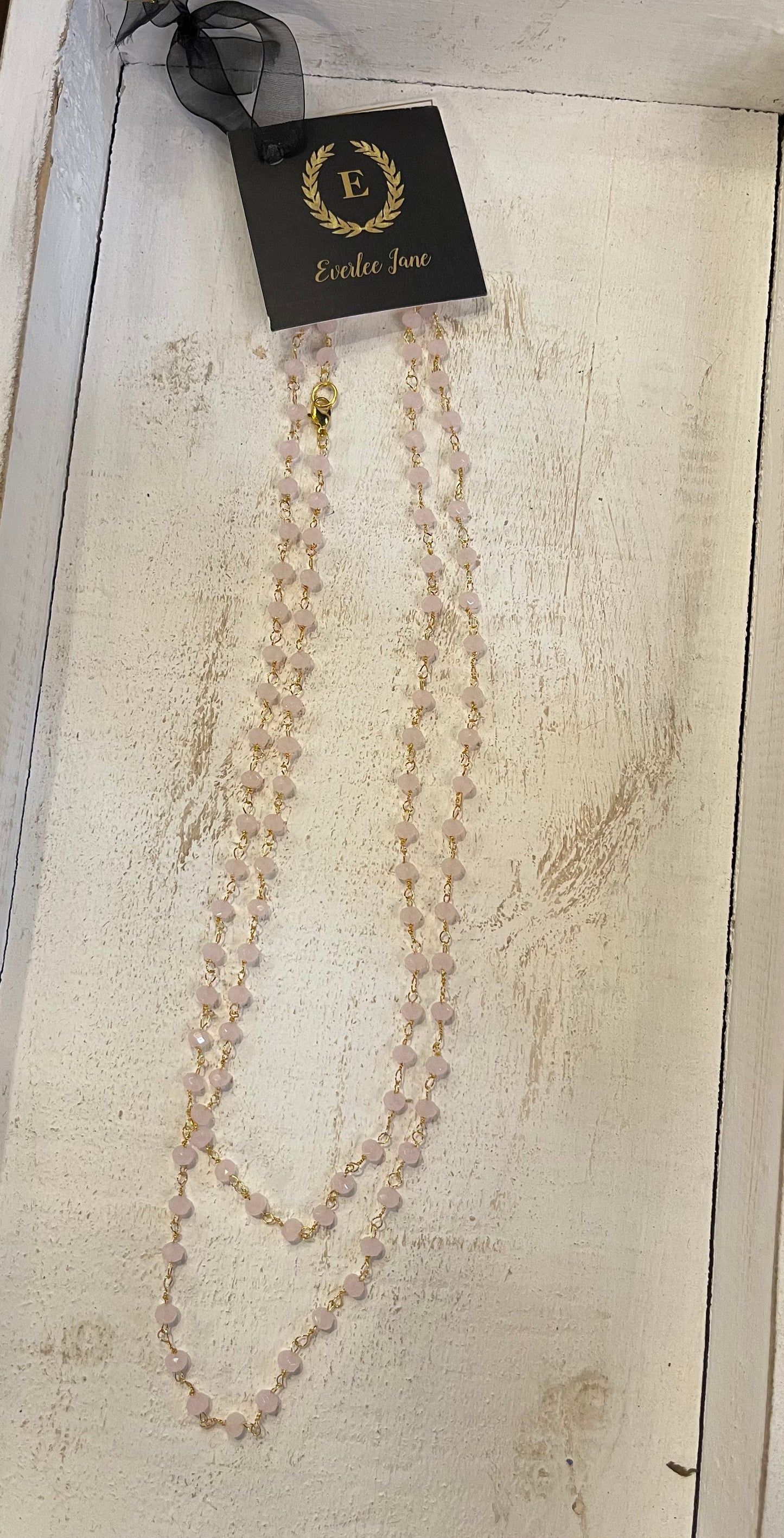 The Bali Stone Necklace features blush stone beads and gold trim; available in S, M, L.