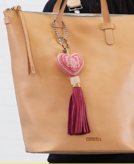 Tan leather tote with "CONSUELA" embossed, pink beaded heart charm, burgundy tassel. Available in small and large sizes.