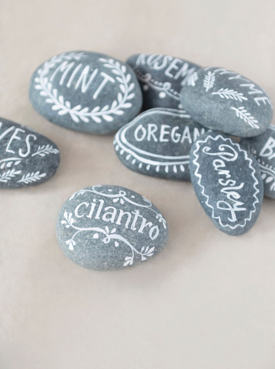 Smooth gray stones, hand-lettered with herb names in white. Available sizes: Small, Medium, Large.