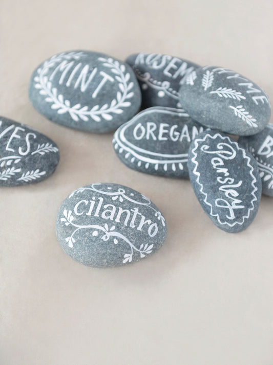 Smooth gray stones, hand-lettered with herb names in white. Available sizes: Small, Medium, Large.