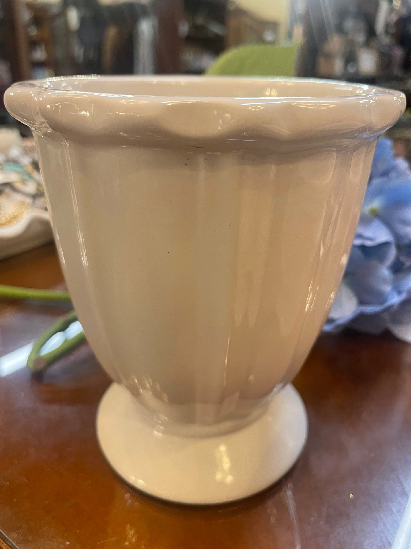 White ceramic vase with fluted design and wide rim. Available in small, medium, and large sizes.