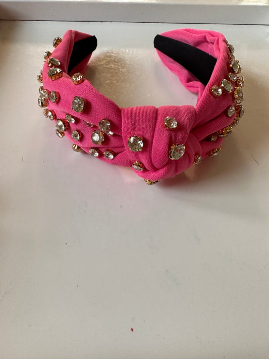 Pink fabric headband with front knot, large clear rhinestones in gold settings. Available in S, M, L.