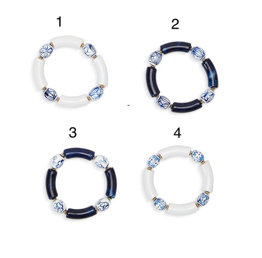 Set of 4 blue and white ceramic bead stretch bracelets; 1 & 4 with white resin, 2 & 3 with dark blue resin. Sizes: S/M, M/L.
