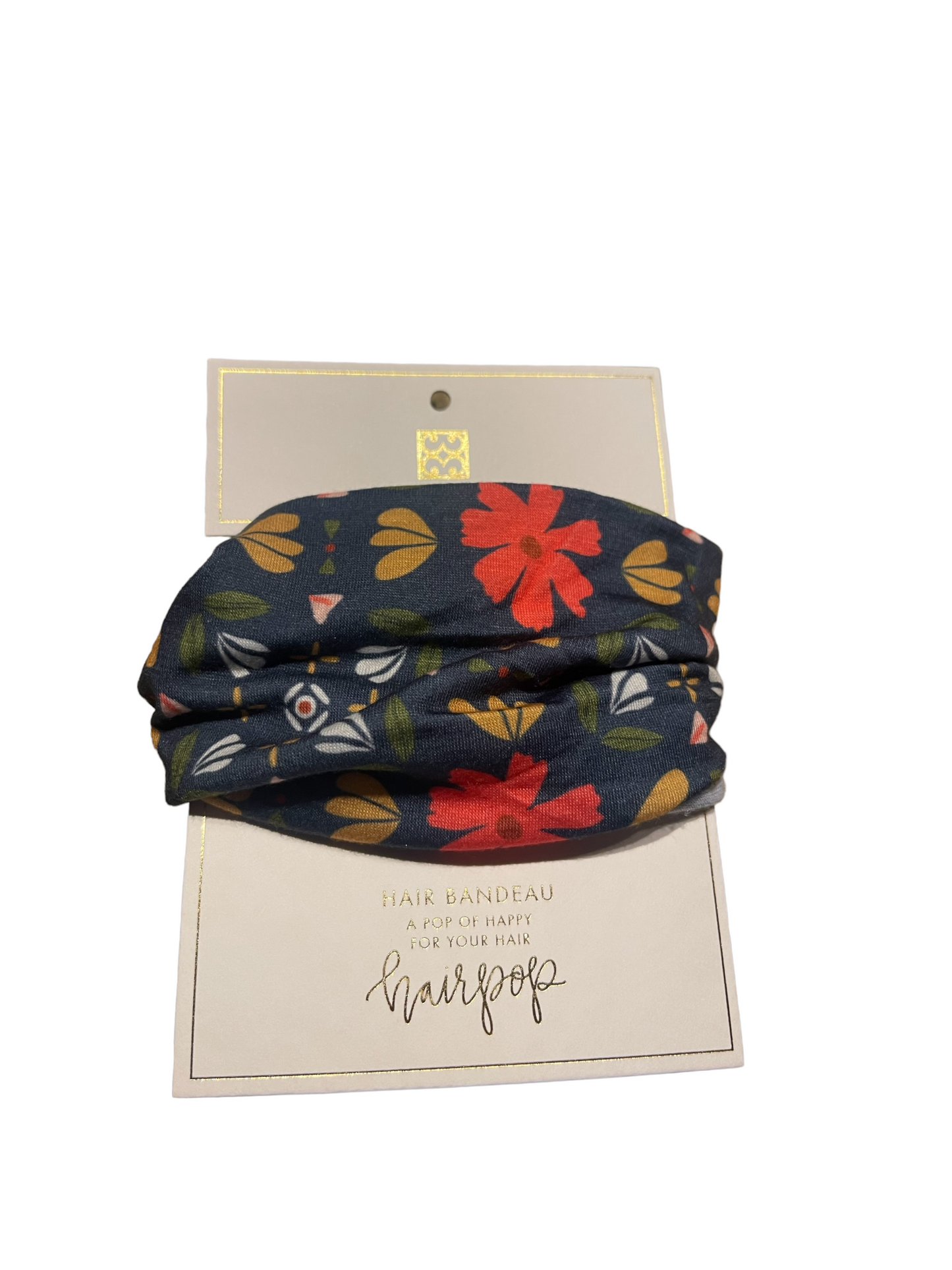 Dark floral-patterned headband on "hairgoop" card with gold details. Available in S, M, and L.