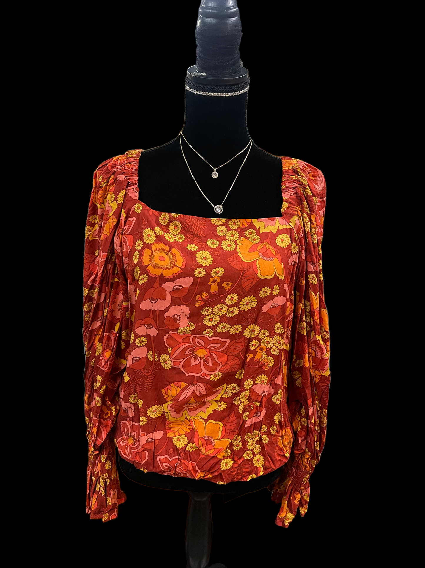 Samba Orange Blouse with square neckline, long ruched sleeves, orange floral print. Available in sizes XS-XL.