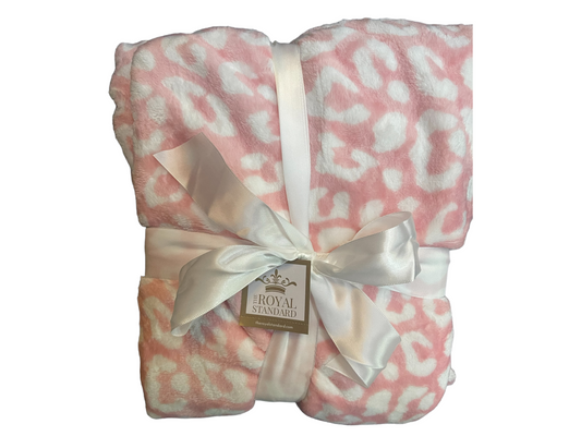 The Wild One Throw, 50x60, light pink and white leopard print, folded with a ribbon and "Royal Standard" tag.