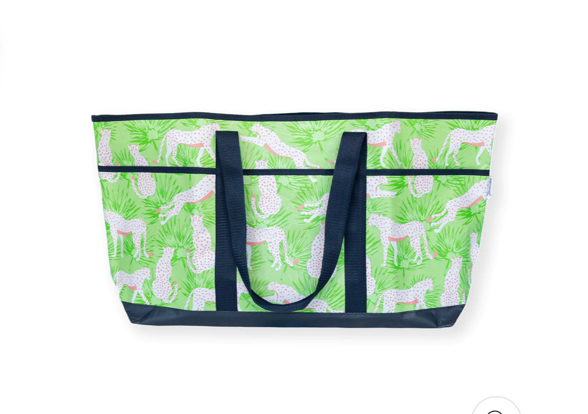 Large tote with navy handles, green base, white giraffe and plant print. Available in one large size.