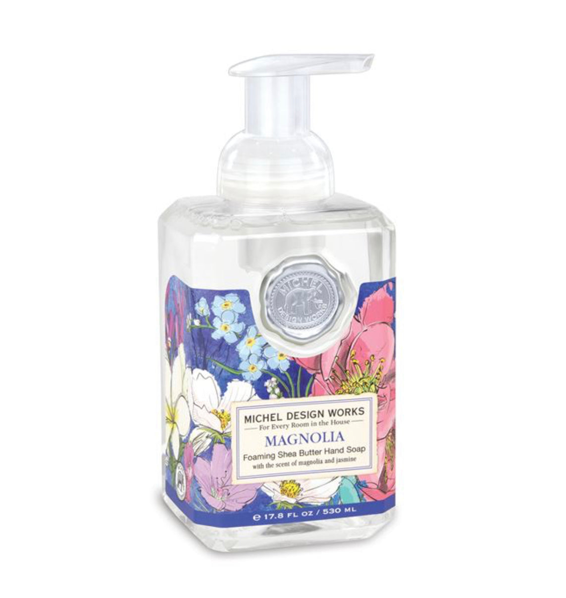 This is a clear bottle of Magnolia Foaming Soap with a floral label and convenient pump dispenser. The translucent design allows for easy visibility of the soap inside.