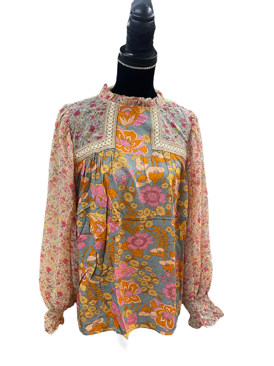 A Brighton Dusty Sage Multi-Color Floral Blouse, constructed from 100% rayon. Features long sleeves and intricate lace detailing on the neckline and shoulders. Available sizes include small, medium, large, and extra-large.