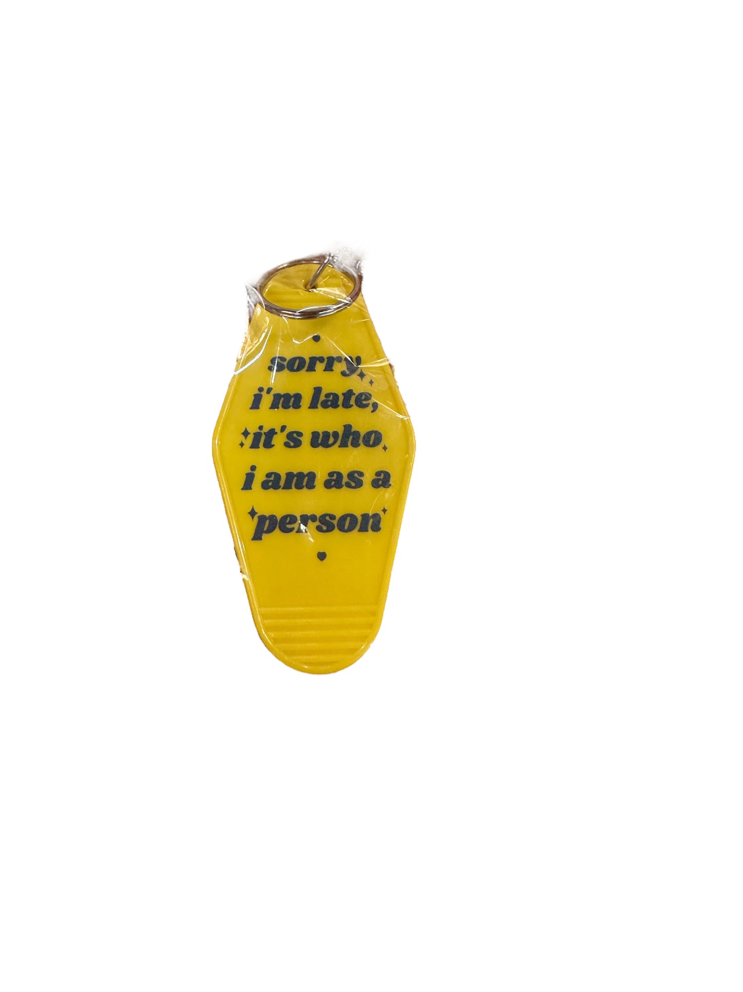 Yellow retro motel keychain with black text: "sorry i'm late, it's who i am as a person." Available in multiple sizes.