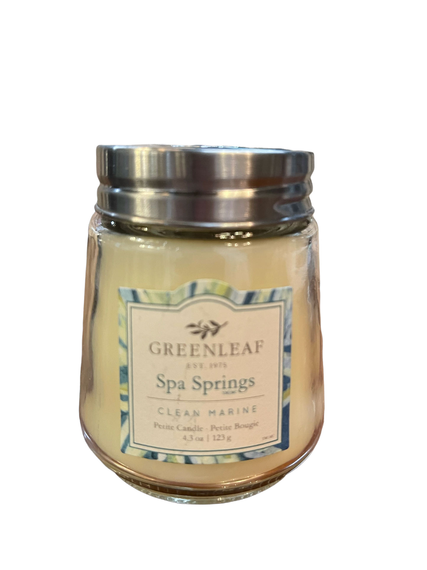 Glass jar candle with silver lid, labeled "Spa Springs Clean Marine." Petite size: 4.3 oz/123g. Creamy pale yellow wax.