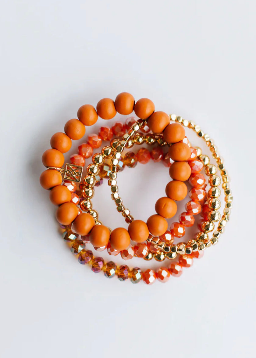 Mandy Bracelets in orange, gold, and clear with varied textures and sizes. Available in small, medium, and large.