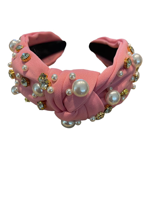 Top Knot Fabric Head Band with central knot, rhinestones, and simulated pearls. Available in one size.