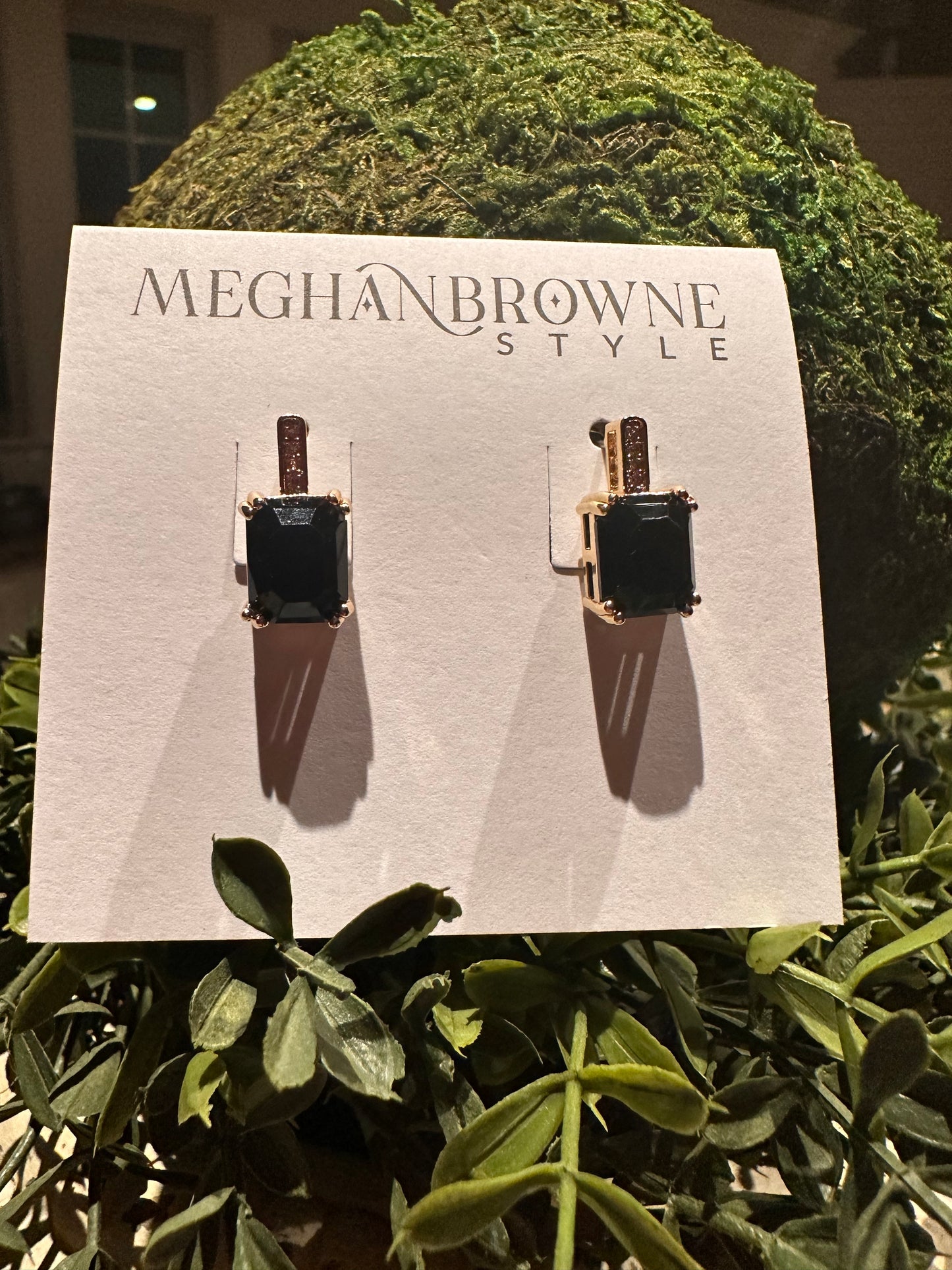 The Tia Jet Earrings feature square dark gemstones in gold settings. Available sizes: small, medium, large.