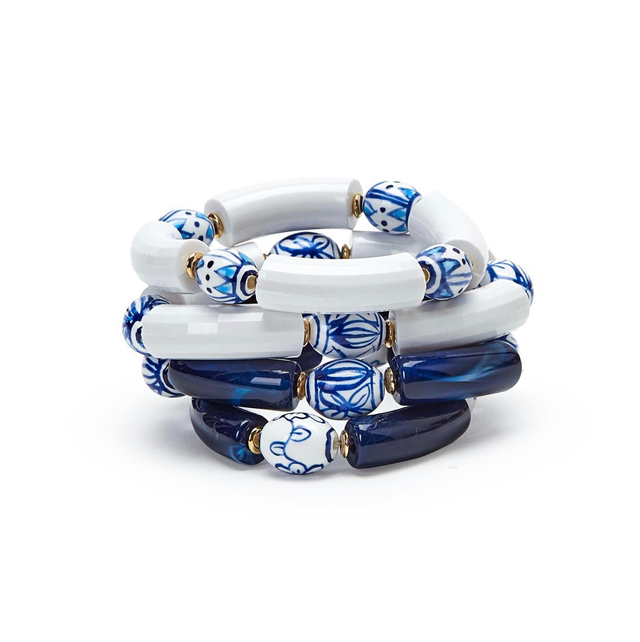 Coiled stretch bracelet with white, blue, and navy beads, gold accents. Sizes: S, M, L.