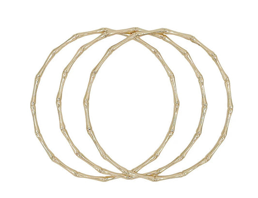Three thin Joss Bangles with textured, bamboo-inspired gold design. Available sizes: S, M, L.