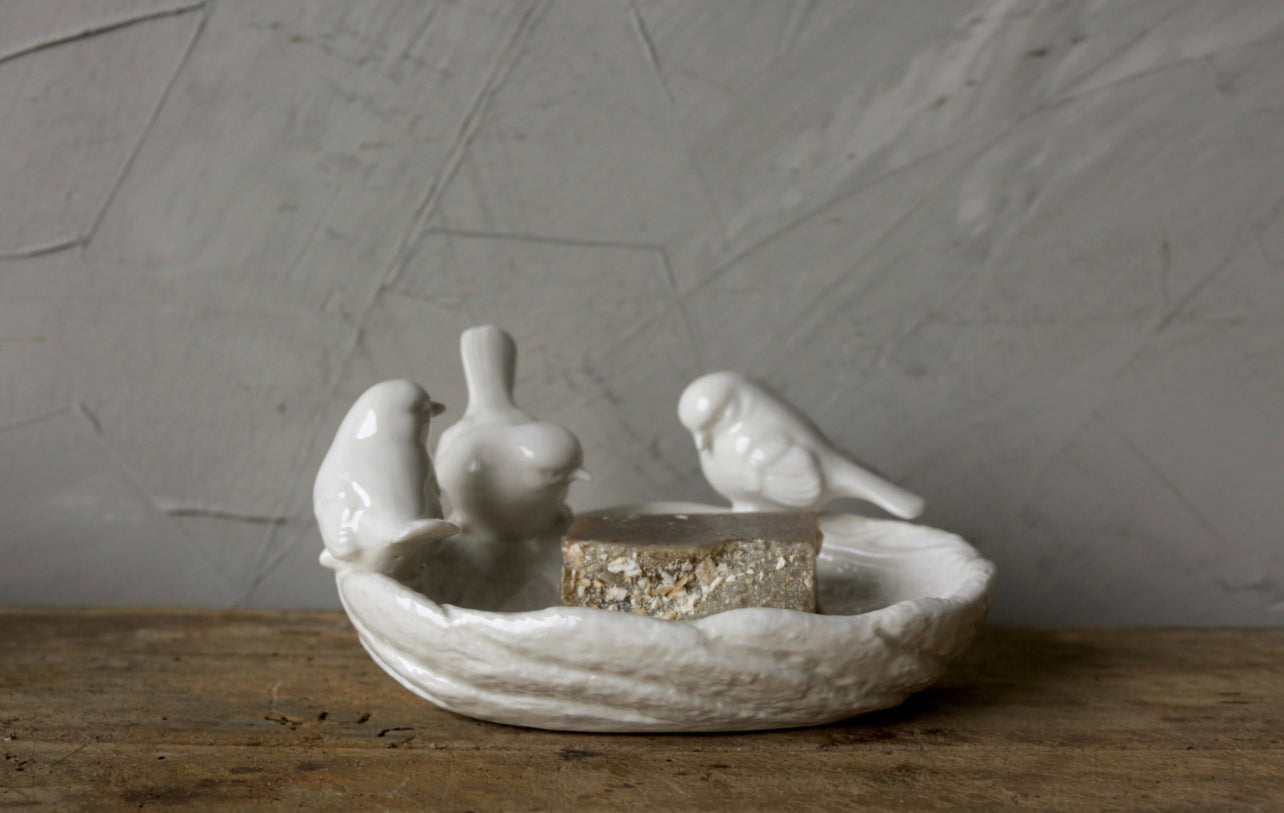White ceramic leaf-shaped dish with three bird figures; holds soap or trinkets. Available in small, medium, and large sizes.
