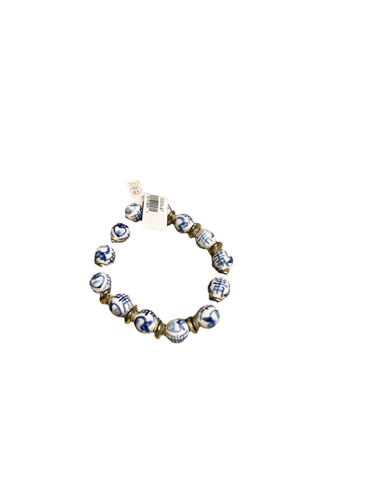 Round blue and white ceramic beads with gold spacer beads form a stretch bracelet. Available sizes: S/M, M/L.