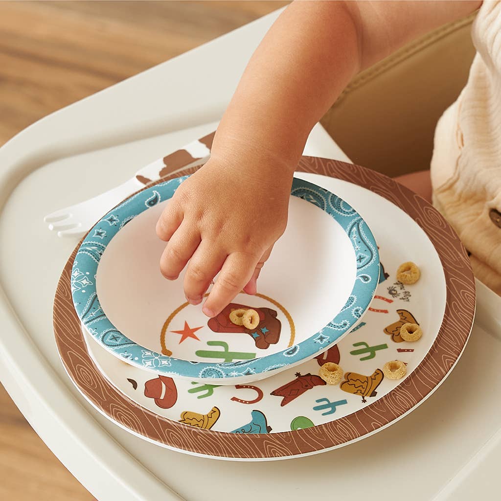 BPA-free Itzy Bistro™ 4-Piece Dining Set with blue-rimmed melamine bowl and cowboy-themed plate, available in toddler sizes.