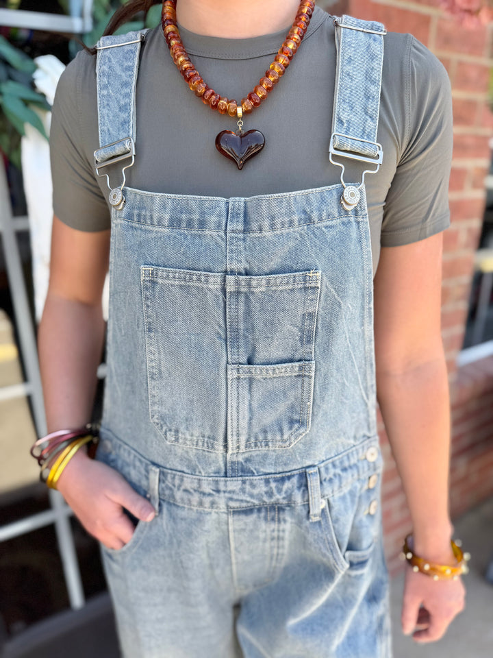 Dakota Mineral Wash Denim Jumpsuit in a relaxed fit and mineral wash finish, available in sizes XS-XL.