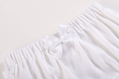 White and pink baby bloomers waistband with soft cotton, elastic band, white ruffles, satin bow. Available in size 3-6M.