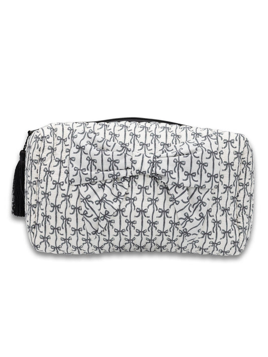 Rectangular quilted white cosmetic bag with black bows, stripes, zipper, and tassel. Available in small and large sizes.