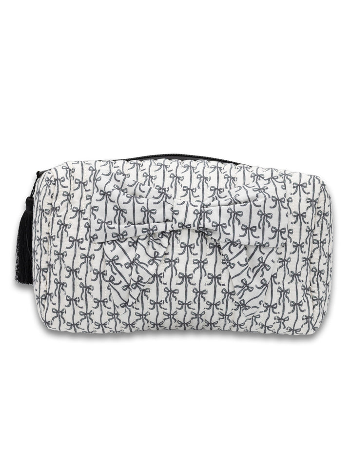 Rectangular quilted white cosmetic bag with black bows, stripes, zipper, and tassel. Available in small and large sizes.