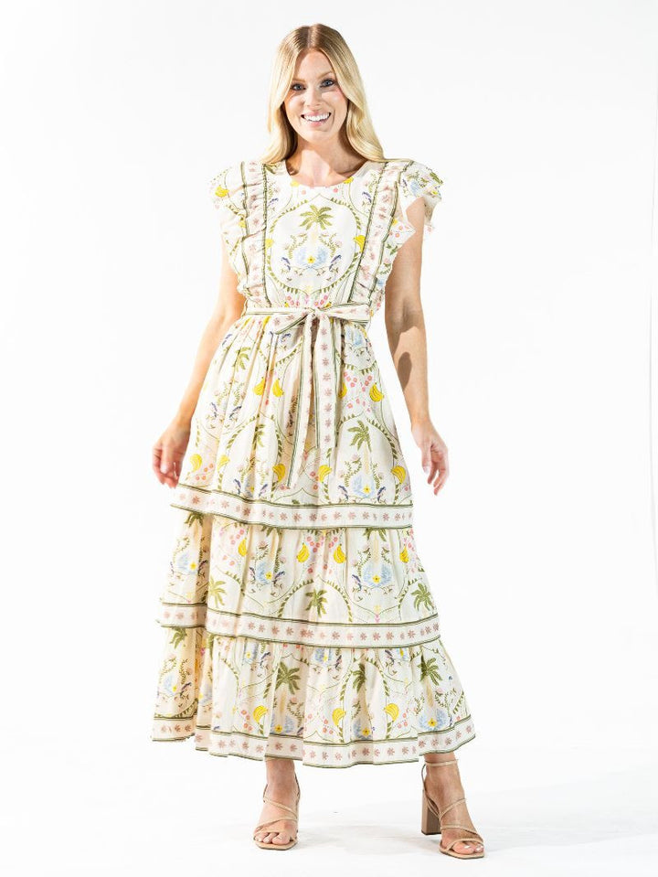 Cabana Tiered Dress: cream 100% cotton maxi with tropical print, tiered skirt, matching belt. Sizes XS-XL.