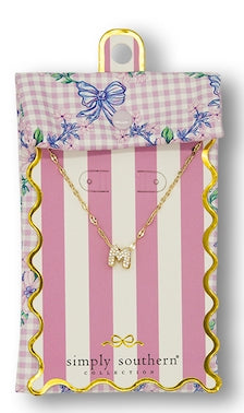 Gold "M" cubic zirconia pendant necklace; pink gingham pouch. Small size.