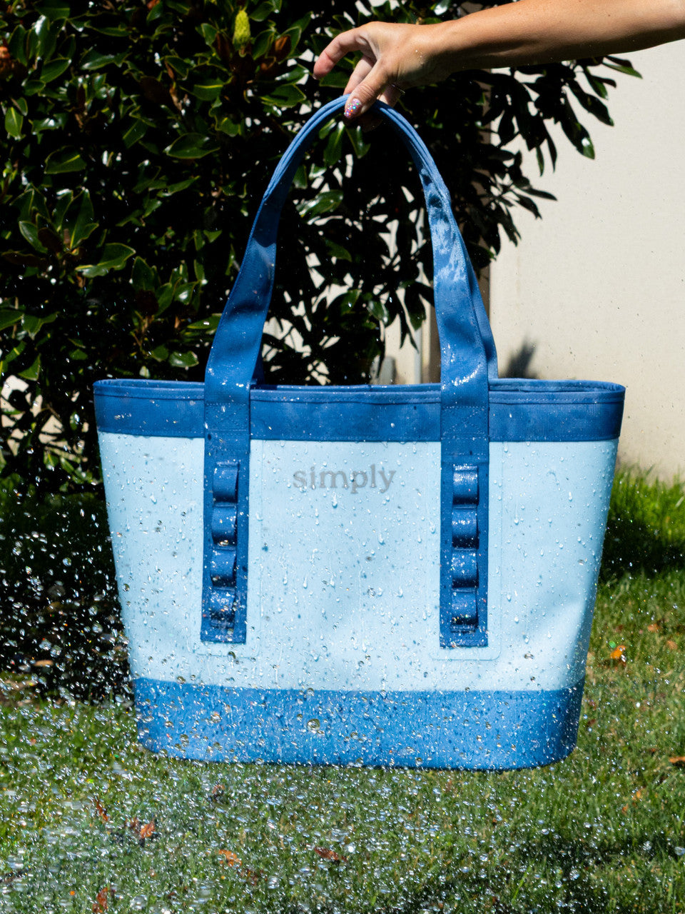 Simply Tough Tote in light/dark blue with water beading on water-resistant surface; available in small, medium, large.